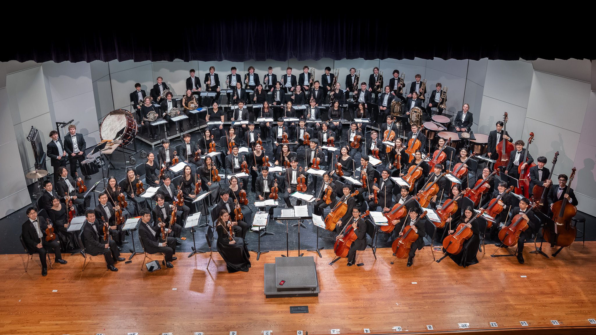 A full orchestra assembled on a concert stage